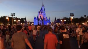 Guests walking toward Cinderella Castle during a summer evening at Walt Disney World.